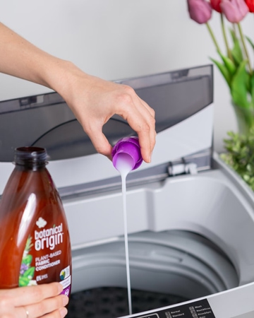 Lady pouring detergent into washing machine